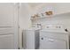 Laundry room with white washer and dryer, and storage shelf for supplies at 527 Clearsable Ave, Henderson, NV 89044