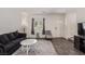 Bright living room with modern furniture, dark wood floors, and neutral walls for versatile decorating at 527 Clearsable Ave, Henderson, NV 89044