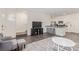 Open concept living space showing the eat-in kitchen, living room furniture, and staircase at 527 Clearsable Ave, Henderson, NV 89044
