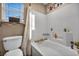 Clean bathroom featuring a shower-tub combination, white tile surround, and a window for natural light at 5308 Carlsbad Heights St, North Las Vegas, NV 89081