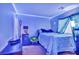Cozy bedroom with blue accents, under-lighting, and window with covering at 5308 Carlsbad Heights St, North Las Vegas, NV 89081