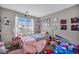 Cozy bedroom featuring bright decor, playful accents, and a charming white metal bed frame at 5308 Carlsbad Heights St, North Las Vegas, NV 89081