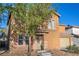 Two-story home featuring a charming front entrance, two-car garage, and low-maintenance desert landscaping at 5308 Carlsbad Heights St, North Las Vegas, NV 89081