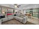 Open concept living area with a gray sectional sofa connecting to the kitchen and bar seating at 5308 Carlsbad Heights St, North Las Vegas, NV 89081