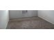 Neutral bedroom with carpet flooring and AC wall unit at 5388 Swenson St # 26, Las Vegas, NV 89119
