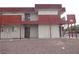 The two-story building features a red staircase and balcony with a ground level rock scape at 5388 Swenson St # 26, Las Vegas, NV 89119