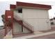 View of building exterior and access stairs with neutral paint and red trim at 5388 Swenson St # 26, Las Vegas, NV 89119