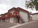 Angle view of apartment exterior with access stairs and balconies and neutral paint at 5388 Swenson St # 26, Las Vegas, NV 89119