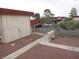 Complex exterior view with red gravel, sidewalk, and building in the background at 5388 Swenson St # 26, Las Vegas, NV 89119