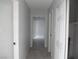 Clean hallway with tile flooring and neutral paint connects rooms seamlessly at 5388 Swenson St # 26, Las Vegas, NV 89119