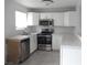 Bright kitchen with stainless steel appliances, white cabinets, and tile flooring at 5388 Swenson St # 26, Las Vegas, NV 89119