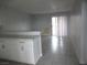 Bright living room featuring tile flooring, neutral walls, and sliding glass doors at 5388 Swenson St # 26, Las Vegas, NV 89119