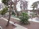 Community pool with fencing, trees, and tables at 5388 Swenson St # 26, Las Vegas, NV 89119