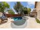 Stunning backyard features a sparkling pool and spa, complemented by a built-in grill and ample patio space at 5452 Desert Spring Rd, Las Vegas, NV 89149