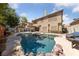 Gorgeous backyard showcasing a pool, spa, covered patio, and lush landscaping, perfect for outdoor relaxation and entertaining at 5452 Desert Spring Rd, Las Vegas, NV 89149