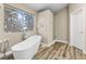 Bright bathroom featuring a standalone tub, large window, and glass shower at 5452 Desert Spring Rd, Las Vegas, NV 89149