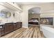 A luxurious bathroom with double vanity sinks, a garden tub, and an open bedroom area at 5452 Desert Spring Rd, Las Vegas, NV 89149