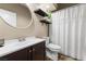 A well-lit bathroom featuring a vanity, toilet, and shower with curtain at 5452 Desert Spring Rd, Las Vegas, NV 89149