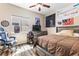 Bedroom with a ceiling fan, neutral walls, and decorative posters on the wall at 5452 Desert Spring Rd, Las Vegas, NV 89149