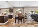 Dining room with hardwood floors, view of the backyard pool, and open to kitchen at 5452 Desert Spring Rd, Las Vegas, NV 89149