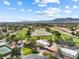 Aerial view of the golf course community surrounded by desert mountains and houses at 5452 Desert Spring Rd, Las Vegas, NV 89149