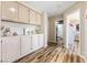 Bright hallway features beautiful wood floors and built-in storage cabinets leading to the bathroom at 5452 Desert Spring Rd, Las Vegas, NV 89149