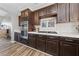 Kitchen showcases dark wood cabinets, stainless steel appliances, gas cooktop and tile backsplash at 5452 Desert Spring Rd, Las Vegas, NV 89149