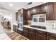 Kitchen featuring stainless steel oven, gas cooktop, dark cabinets, and tiled countertops at 5452 Desert Spring Rd, Las Vegas, NV 89149