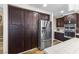 Kitchen with stainless steel refrigerator, dark cabinets, and tiled countertops at 5452 Desert Spring Rd, Las Vegas, NV 89149