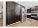 Kitchen features dark wood cabinets and stainless steel refrigerator offering ample storage and functionality at 5452 Desert Spring Rd, Las Vegas, NV 89149