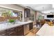 Bright kitchen with stainless steel appliances, dark wood cabinets, and view into dining room at 5452 Desert Spring Rd, Las Vegas, NV 89149