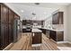 Spacious kitchen featuring dark wood cabinetry, stainless steel appliances, and a center island with tile countertops at 5452 Desert Spring Rd, Las Vegas, NV 89149