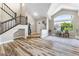 Inviting living room featuring a staircase and a large arched window at 5452 Desert Spring Rd, Las Vegas, NV 89149