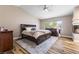 Spacious main bedroom featuring a fireplace, hardwood floors, ceiling fan and natural light at 5452 Desert Spring Rd, Las Vegas, NV 89149