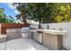Outdoor kitchen including grill, sink, refrigerator and ample counter space at 5452 Desert Spring Rd, Las Vegas, NV 89149