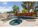 A beautiful backyard pool and hot tub area for entertaining and relaxation, set against a decorative fence line at 5452 Desert Spring Rd, Las Vegas, NV 89149