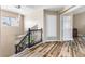 Entryway at the top of stairs with lovely wood flooring and staircase banister at 5452 Desert Spring Rd, Las Vegas, NV 89149