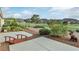 View of backyard with desert landscaping, patio, and golf course in the background at 585 Mountain Links Dr, Henderson, NV 89012