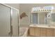 Bathroom boasting a tub, double sinks, and ample lighting with a neutral color palette at 585 Mountain Links Dr, Henderson, NV 89012