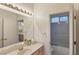 Bathroom with double sinks, tile flooring, ample counter space, and vanity mirror at 585 Mountain Links Dr, Henderson, NV 89012