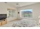 Bright bedroom with large windows offering scenic mountain views and a ceiling fan at 585 Mountain Links Dr, Henderson, NV 89012