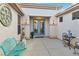 Inviting front entry featuring a private courtyard, double glass doors, and custom seating at 585 Mountain Links Dr, Henderson, NV 89012