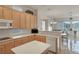 Bright kitchen with wrap around counters, island with cooktop, lots of storage and a view of the golf course at 585 Mountain Links Dr, Henderson, NV 89012