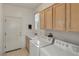 Functional laundry room with washer, dryer, sink, and storage cabinets at 585 Mountain Links Dr, Henderson, NV 89012