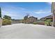 Spacious backyard with basketball hoop and building with the word 'Garden' on it at 6208 W Rome Blvd, Las Vegas, NV 89131