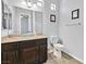 Bathroom featuring a marble vanity, dark brown cabinets, a toilet, and a large mirror at 6208 W Rome Blvd, Las Vegas, NV 89131