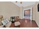 Bedroom featuring hardwood floors, comfortable chair, small desk, and a window with natural light at 6208 W Rome Blvd, Las Vegas, NV 89131
