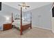 Spacious bedroom with a four-poster bed, side table, and natural light from the window at 6208 W Rome Blvd, Las Vegas, NV 89131
