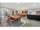 Open-concept dining area with wooden table and chairs, connecting to a kitchen with pendant lighting at 6208 W Rome Blvd, Las Vegas, NV 89131