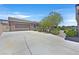 Single-story home showcasing a spacious driveway, attached garage, and well-maintained landscaping at 6208 W Rome Blvd, Las Vegas, NV 89131